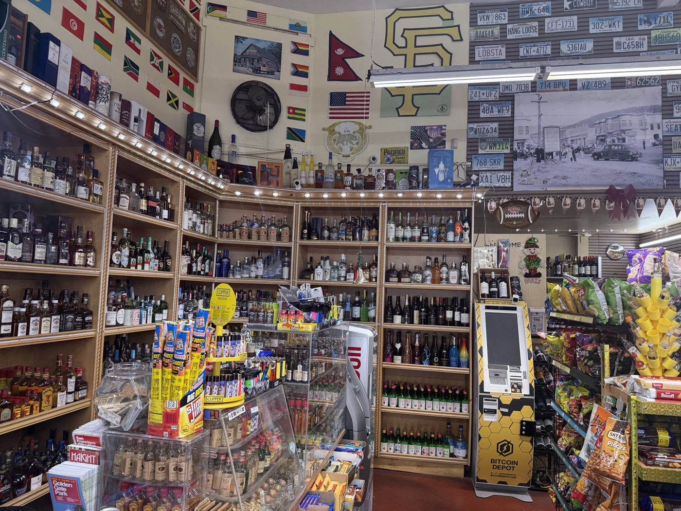 Inside Eddy's Market — the whiskey corner with license plates and SF memorabilia
